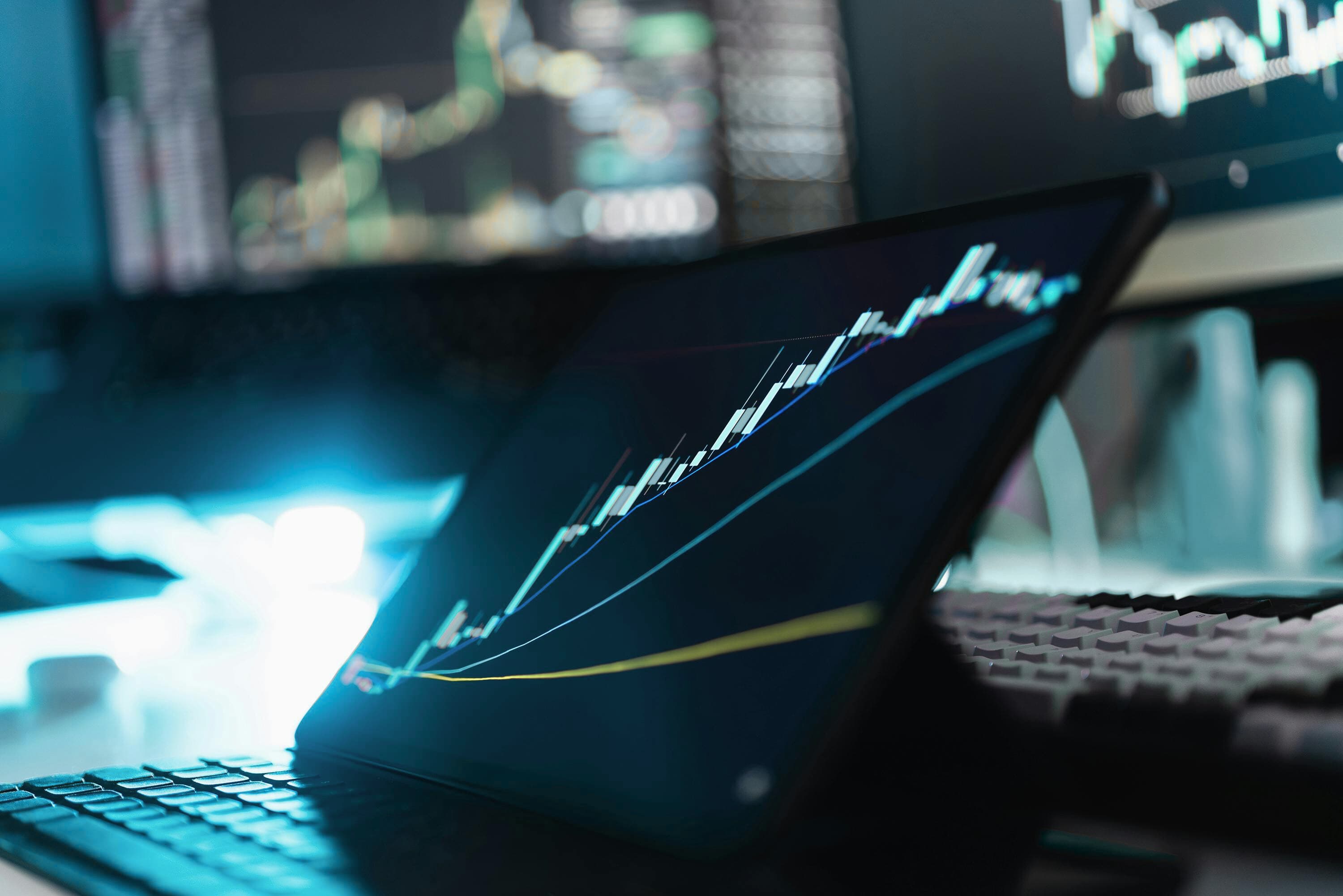 Fintech specialist using phone and laptop for digital finance